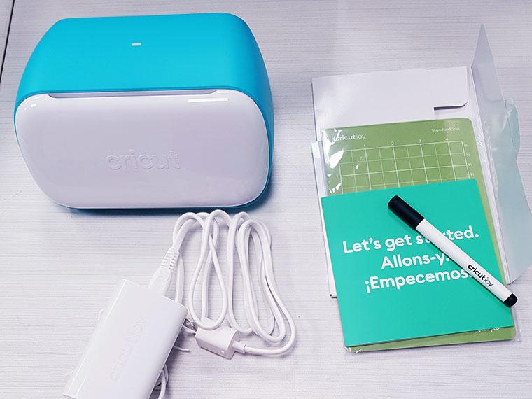 Cricut Joy and accessories on a tabletop.