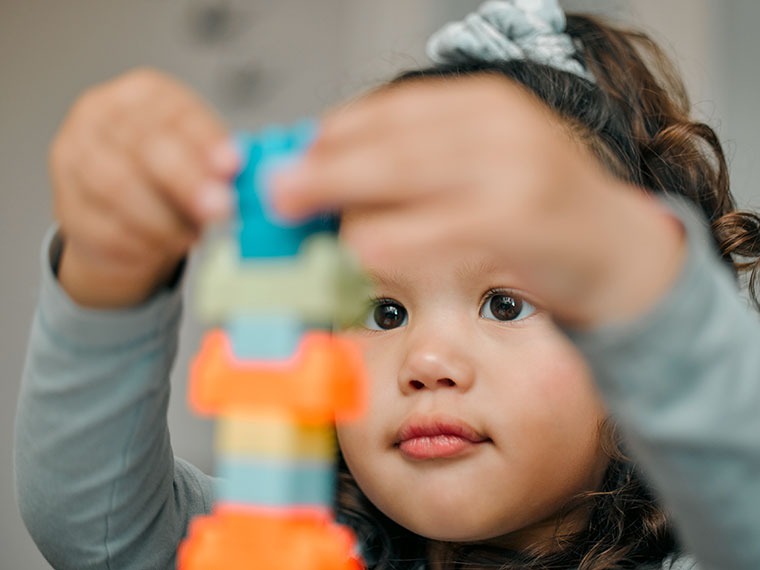 child playing with building blocks