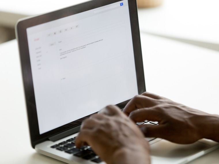 hands typing on a laptop