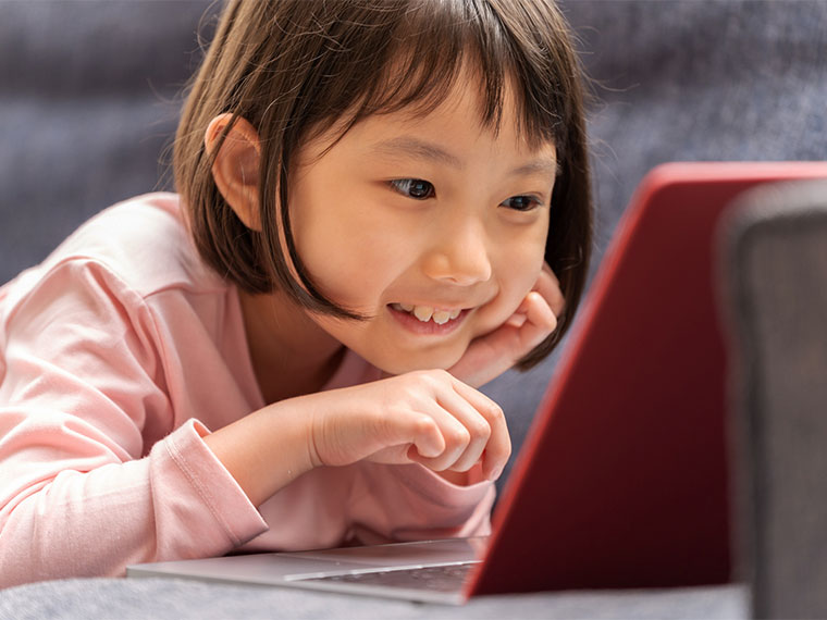 child looking at laptop