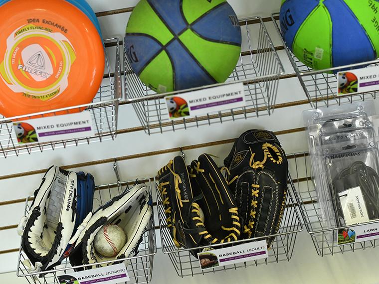Active Living display at Clemens Mill with baseball gloves, disks, and basket balls. 