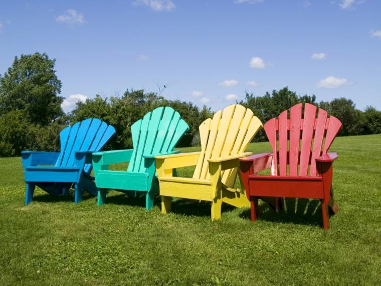 Colourful Adirondack chairs on the grass