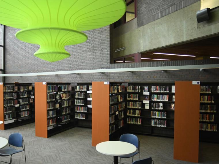 Inside view of shelves, tables, and Beacon (2011) by Lyn Carter at the Queen's Square library.