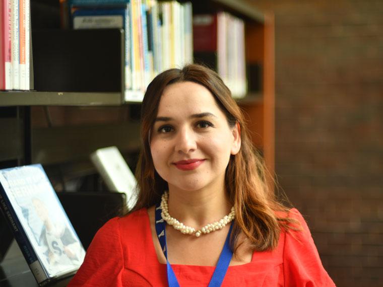 Tuba Sengul, Library Settlement Worker in the library.