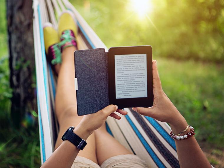 Person reading an eBook in the hammock with the sun shinning.
