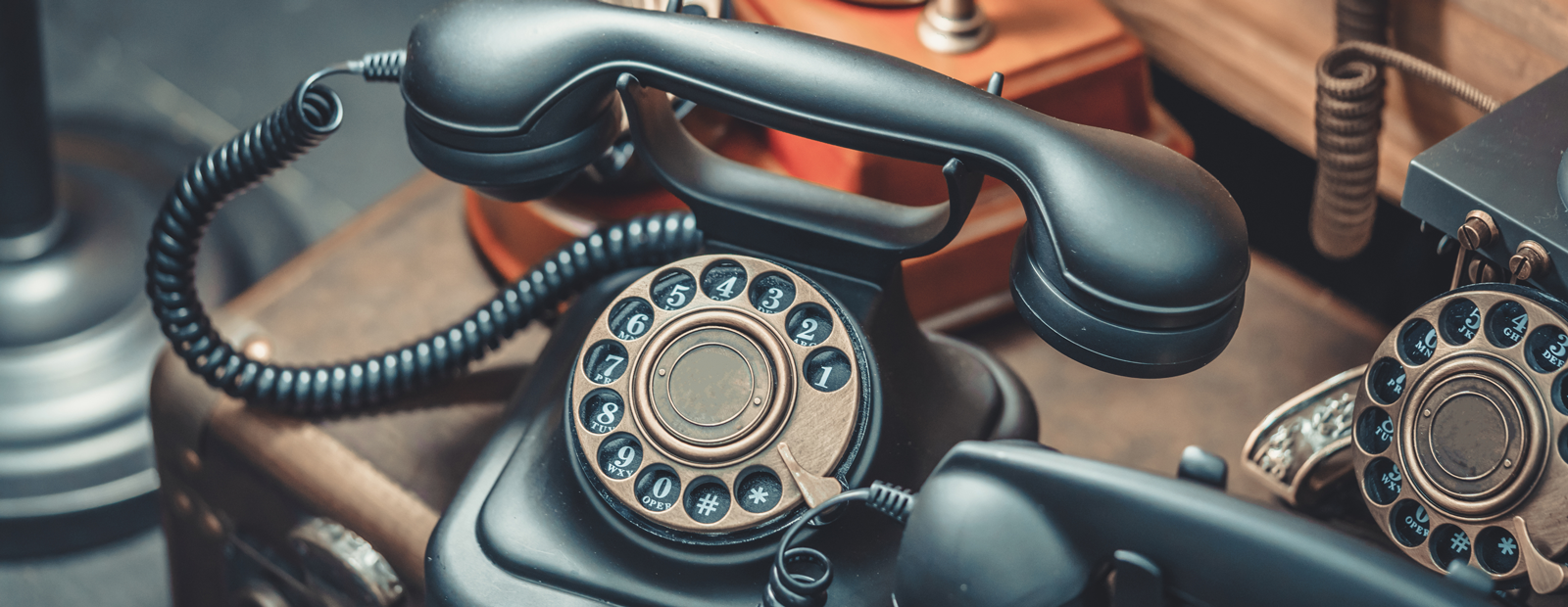 A collection of vintage rotary telephones.