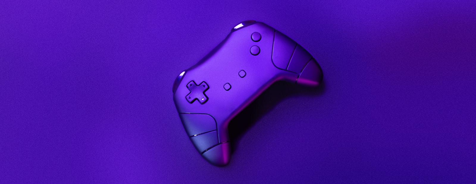 A purple controller sits on a purple surface.