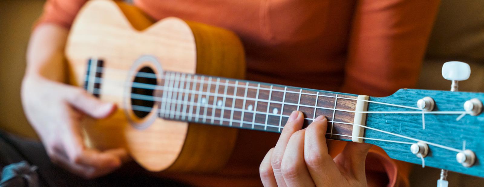 A person playing a ukulele.