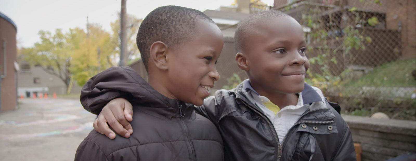 Screen image of two children from the film Unspoken Tears.