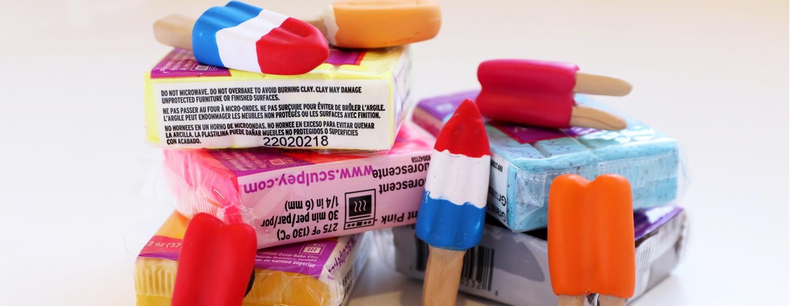 A photograph of mini, brightly coloured, popsicle sculptures made out of sculpey