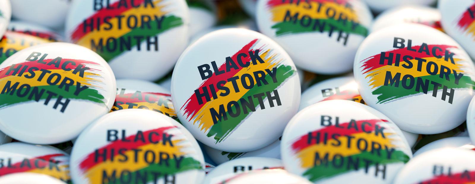 A collection of buttons with Black History Month printed on them.