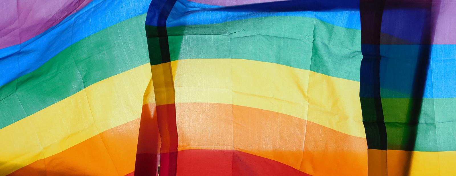 Sunlight through LGBT rainbow flags.