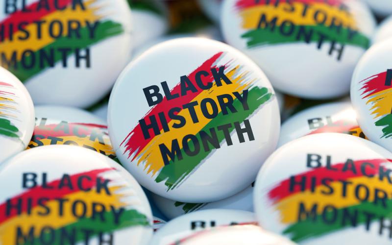 A collection of buttons with Black History Month printed on them.