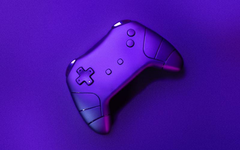 A purple controller sits on a purple surface.