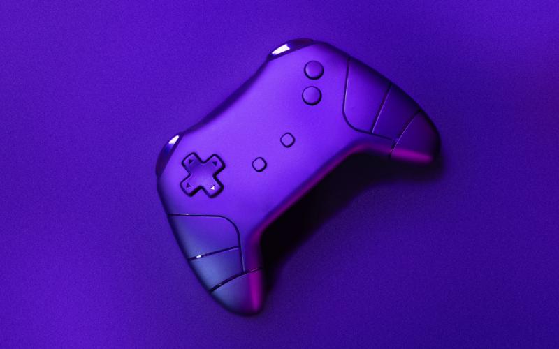 A single game controller sits on a open surface.